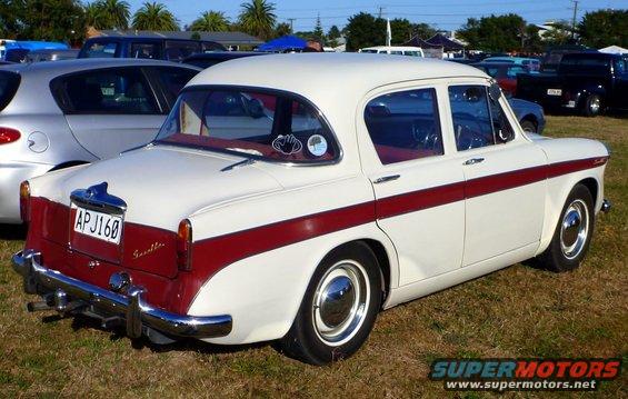 Rear view of white and red sedan with red stripe, license plate AP J160