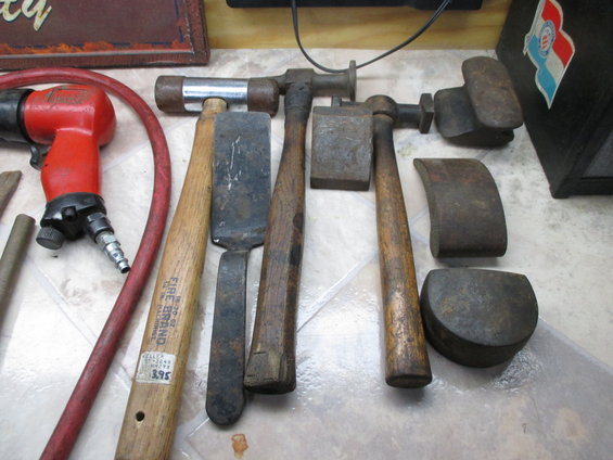 Body hammers and dollies with air hammer and red hose