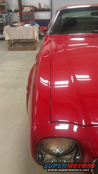 Red 1972 Pontiac Trans Am front fender and headlight detail