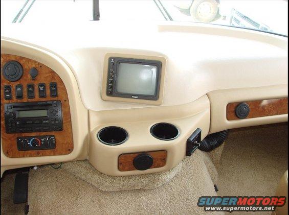 RV dashboard with wood trim, radio, climate controls, and a screen