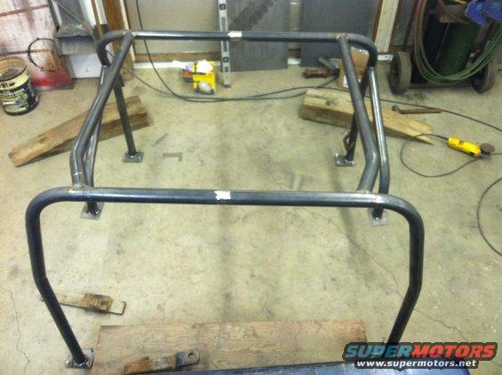 Metal roll cage frame with four mounting points on the floor