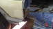 1979 Ford Bronco - Repair work on a vehicle's body panel reveals rust and necessary tools for restoration.