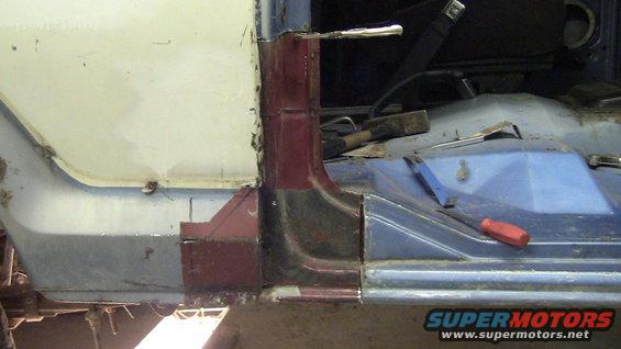 Close-up of vehicle interior showing rust repair and bodywork on the door frame and floor pan. Tools are visible