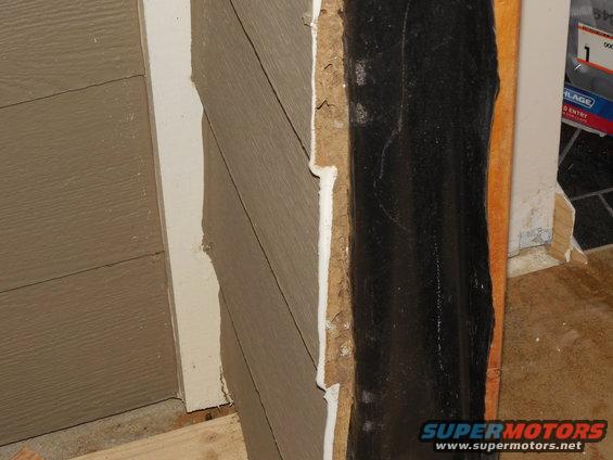 02door7.jpg After pulling the door out, I could see that they had really gone after the siding.  I'll probably hire a pro to replace that after I re-set the door.