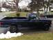 2004 Ford Crown Victoria - This dark blue pickup truck, identified by an F-150 badge, is parked on a residential street.