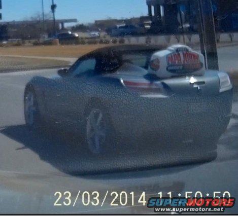 Silver convertible sports car rear view with Papa John's pizza warmer on trunk