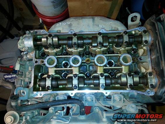 Engine valve cover with camshafts and rockers visible