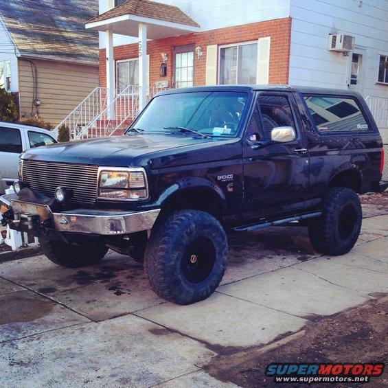 Black 1995 Ford Bronco, 3q-front view, lifted with large tires and chrome grille
