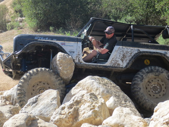 1989 Ford Bronco off-roading over large rocks