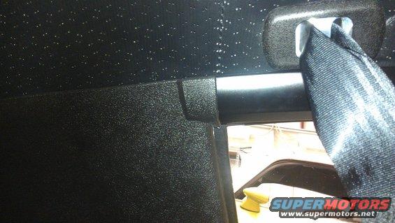 Black interior seatbelt and textured headliner with visible sparkles