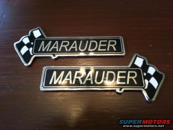 Two Mercury Marauder emblems with checkered flags