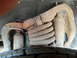 1995 Ford Bronco - Close-up view of heavily rusted suspension components and a tire.