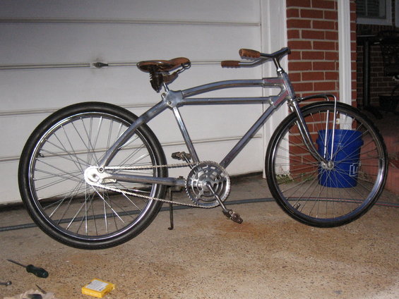 Custom bicycle with chrome frame, leather saddle, and wide tires