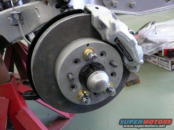 Silver Corvette brake caliper with 'CORVETTE' text, attached to rotor