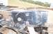 1990 Ford Bronco - The underside of a vehicle shows heavily rusted frame components and suspension parts, with a white paper partially visible.