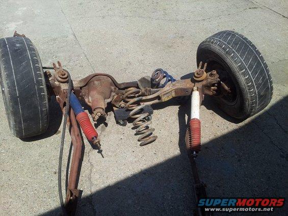 Rear axle assembly with two wheels, springs, and shocks