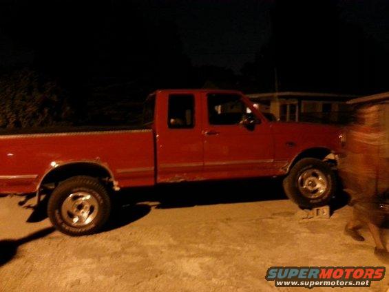 Side view of a red 1995 Ford F-150 pickup truck