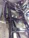 1995 Ford F-150 - Vehicle frame undergoing painting and maintenance in a workshop setting.