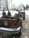 1995 Ford F-150 - This 1995 Ford F-150 chassis is missing its front end and is being towed in the snow.