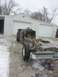 1995 Ford F-150 - A person works on the engine of a 1995 Ford F-150 chassis outside a garage.