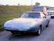 1972 Ford Ranchero - A blue 1970 Plymouth Superbird is parked on a gravel road, towing a camper shell.