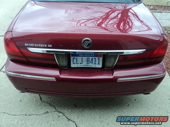 Rear of a red Mercury Grand Marquis GS with a Michigan license plate CLJ 8411