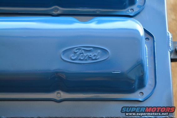 Close-up of blue painted Ford valve covers with embossed Ford oval logo