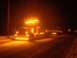 2003 Peterbilt 379 - A truck is illuminated by its many amber lights while driving on a snowy road in the dark.