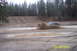1990 Ford Bronco - An SUV navigates a muddy track, kicking up a large spray of dirt and water.