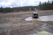 1990 Ford Bronco - Jeep Wrangler navigates a muddy terrain with standing water.