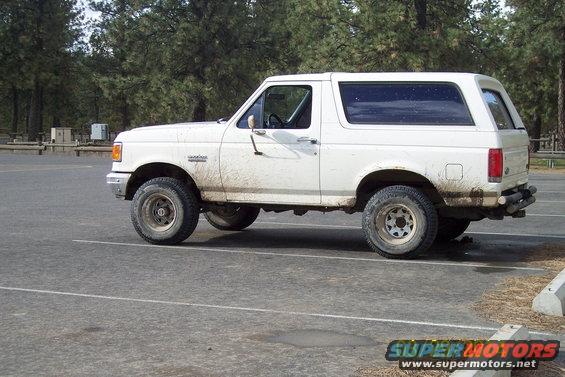 White 1990 Ford Bronco parked in a lot, side view