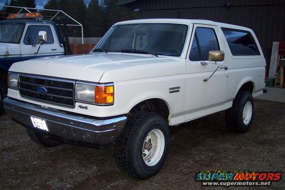 White 1990 Ford Bronco 3q-front view. Visible text: 4x4