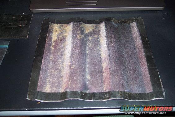 Corrugated metal panel with black trim
