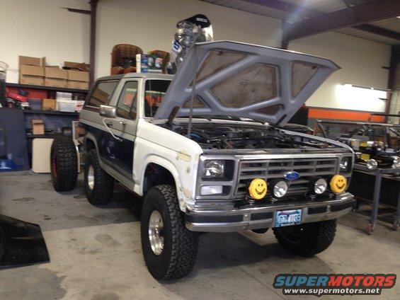 1986 Ford Bronco front with hood open, two smiley face lights