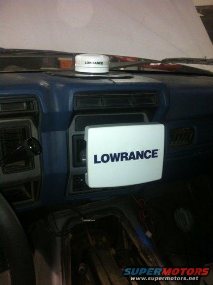Interior view of a vehicle dashboard with a Lowrance GPS unit