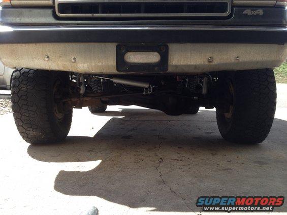 1990 Ford Bronco front underside with large tires and suspension components visible