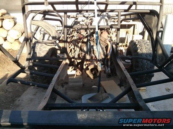 Off-road buggy frame with engine being worked on