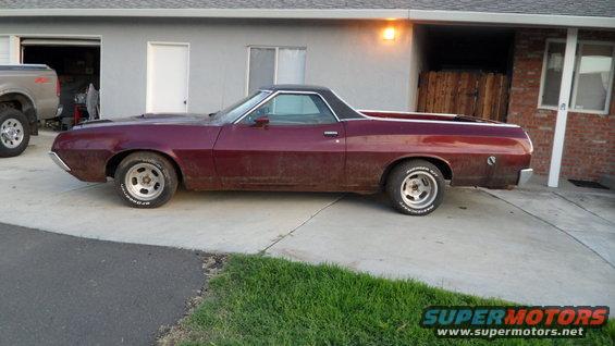 Maroon 1972 Ford Ranchero parked in driveway next to a pickup truck