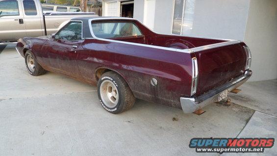 1972 Ford Ranchero parked on concrete, rear 3/4 view. Another truck is parked to the left
