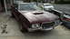1972 Ford Ranchero - A maroon 1972 Ford Ranchero is parked on a concrete surface next to a trailer.