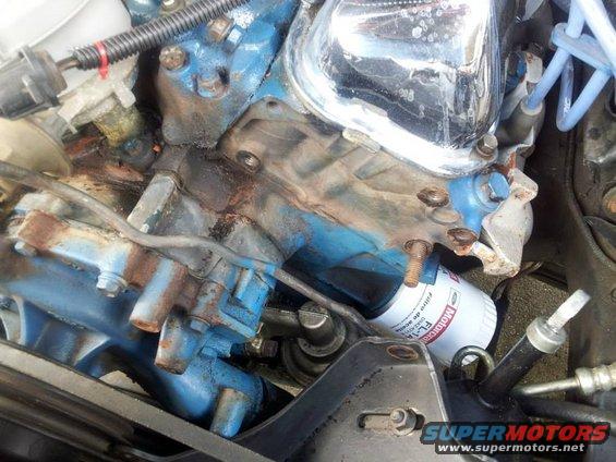 Motorcraft oil filter on a blue engine block with rust and grime