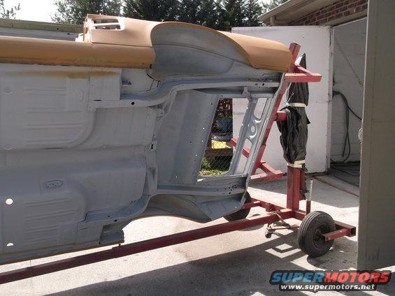 1967 Ford Mustang body on rotisserie, primer finish