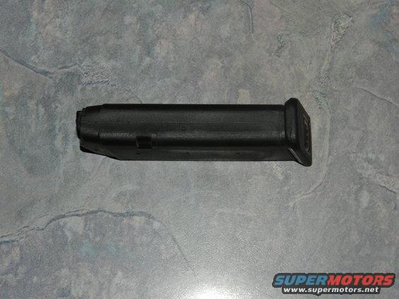 Black gun magazine on a textured surface