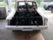 1964 Ford Fairlane - A car is being worked on, with its engine being installed. Another vehicle is visible in the background.