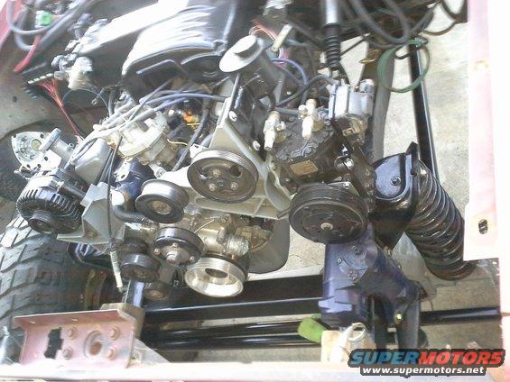 close-up of engine pulleys and belts, part of a vehicle's V-belt system