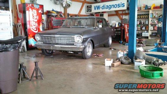 1963 Chevrolet Nova in a garage with tools and a Coca-Cola machine