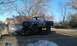 1978 Ford Bronco - A 1978 Ford Bronco is transported on a trailer, showing its disassembled front end and side profile.