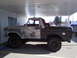 1978 Ford Bronco - This vintage Ford Bronco is undergoing restoration, with visible primer and rust patches on its body.