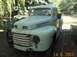 1950 Ford F-250 - This light green pickup truck is parked outside with trees in the background.