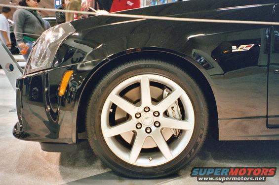 Black Cadillac CTS-V front fender and wheel, showing a 'V' badge on the fender